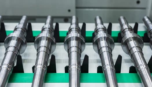 Machined shafts moving along a transfer line